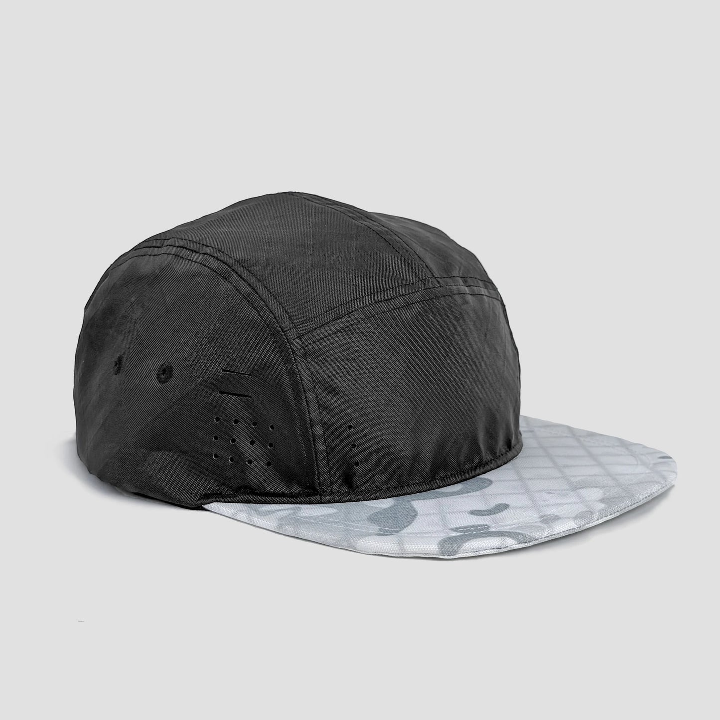 Utility hat made of durable waterproof coated ECOPAK™ fabric, with multiple laser-cut slits and ventilation openings, quick release adjustment strap, and reflexive tab for night time visibility.