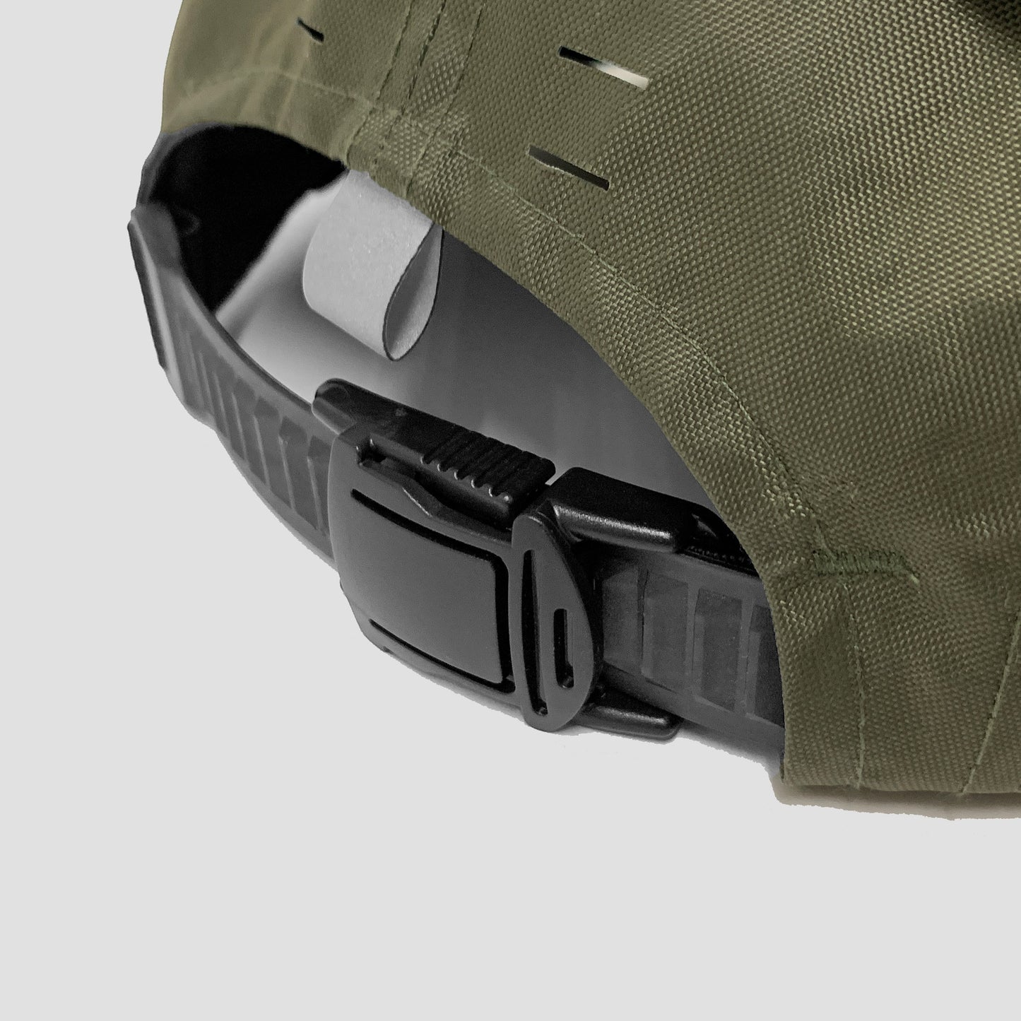 Utility hat made of durable waterproof coated ECOPAK™ fabric, with multiple laser-cut slits and ventilation openings, quick release adjustment strap, and reflexive tab for night time visibility.