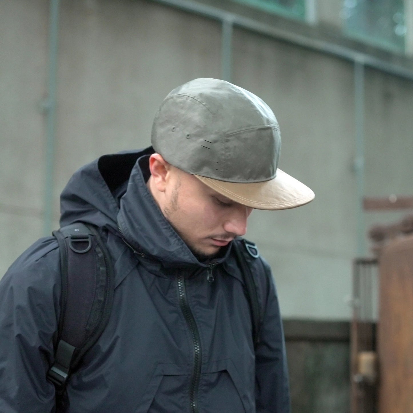 Utility hat made of durable waterproof coated ECOPAK™ fabric, with multiple laser-cut slits and ventilation openings, quick release adjustment strap, and reflexive tab for night time visibility.