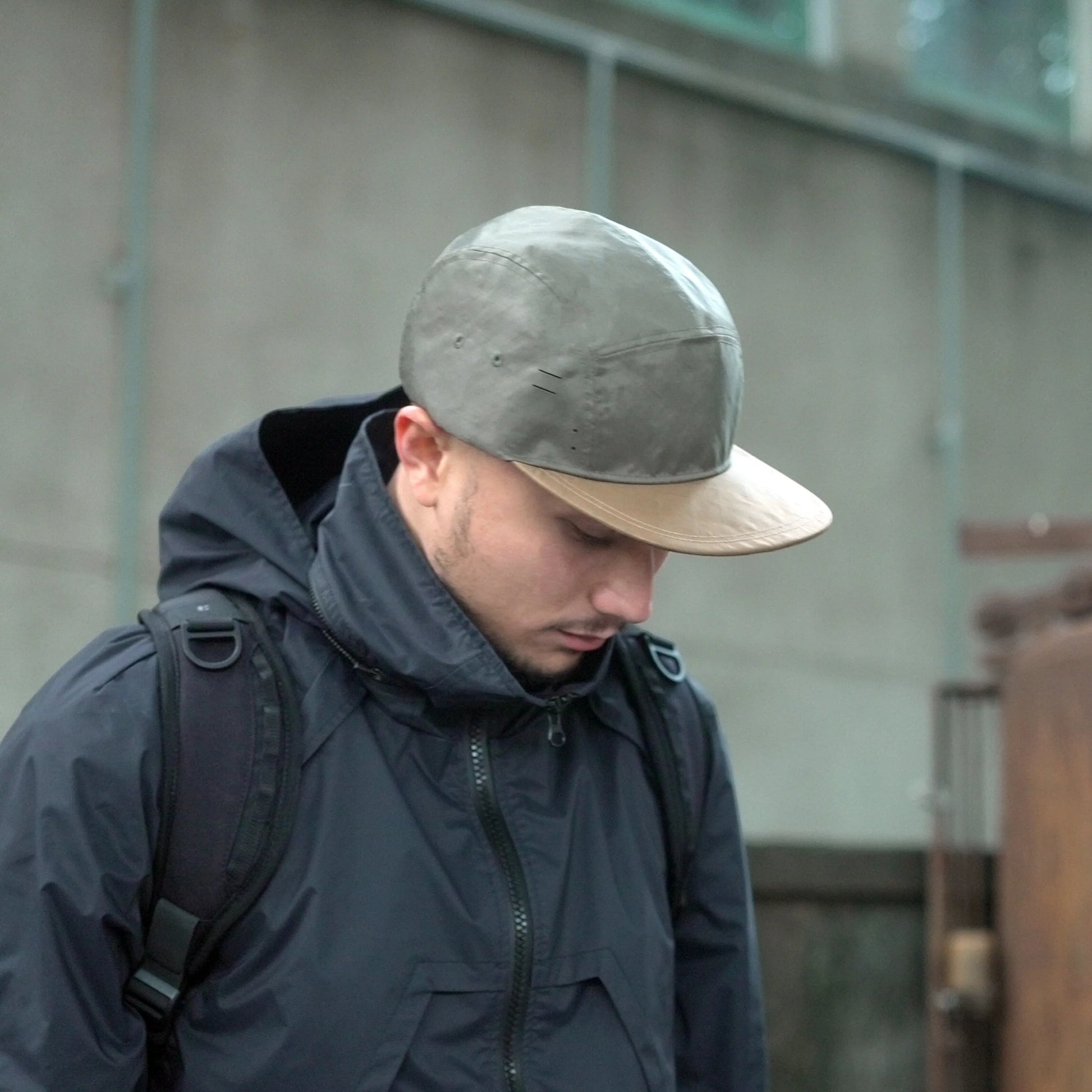 Utility hat made of durable waterproof coated ECOPAK™ fabric, with multiple laser-cut slits and ventilation openings, quick release adjustment strap, and reflexive tab for night time visibility.