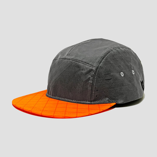 Utility hat made of durable waterproof coated ECOPAK™ fabric, with multiple laser-cut slits and ventilation openings, quick release adjustment strap, and reflexive tab for night time visibility.