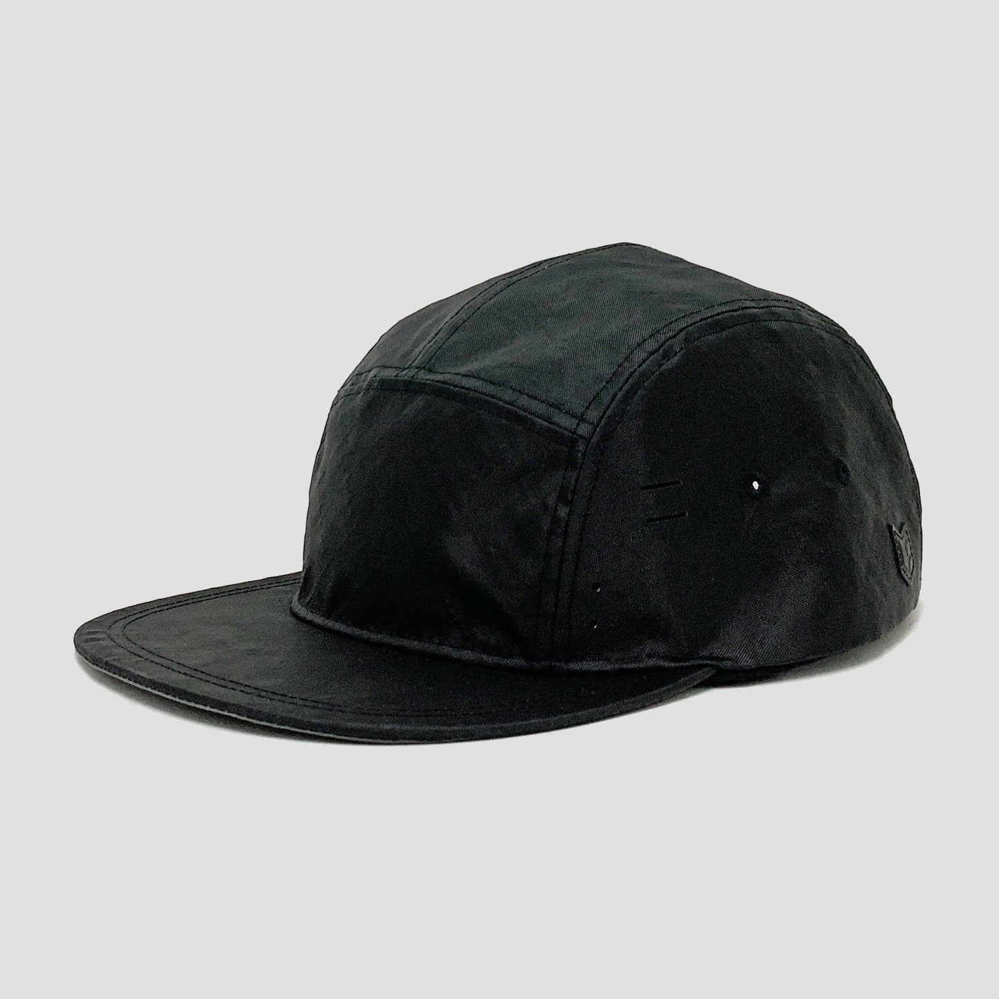 Utility hat made of durable waterproof coated ECOPAK™ fabric, with multiple laser-cut slits and ventilation openings, quick release adjustment strap, and reflexive tab for night time visibility.