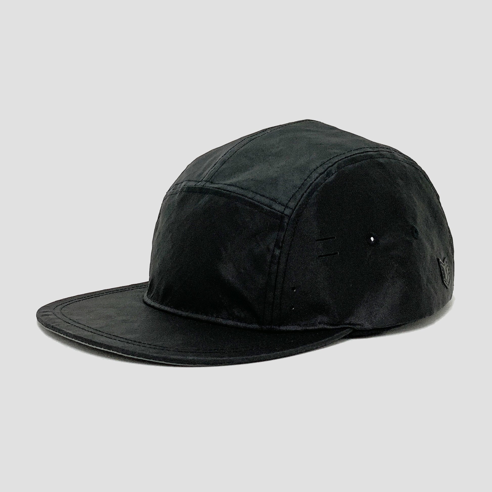 Utility hat made of durable waterproof coated ECOPAK™ fabric, with multiple laser-cut slits and ventilation openings, quick release adjustment strap, and reflexive tab for night time visibility.