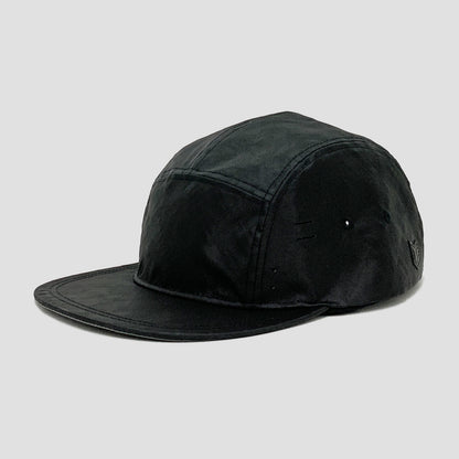 Utility hat made of durable waterproof coated ECOPAK™ fabric, with multiple laser-cut slits and ventilation openings, quick release adjustment strap, and reflexive tab for night time visibility.